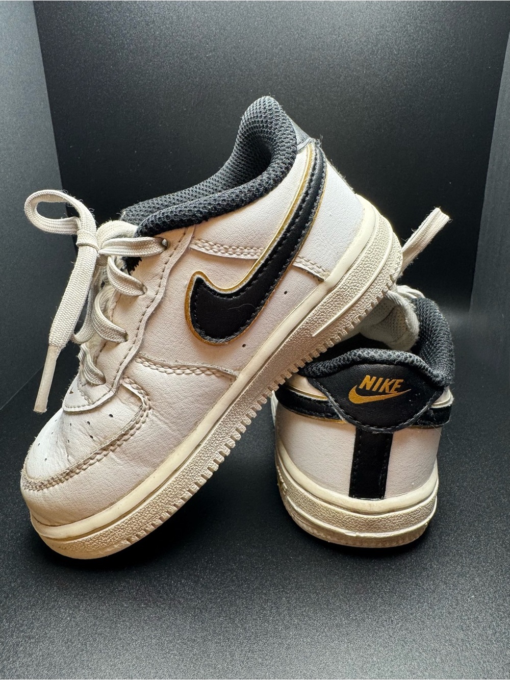 Nike Kids White Sneakers with Black & Gold Accents